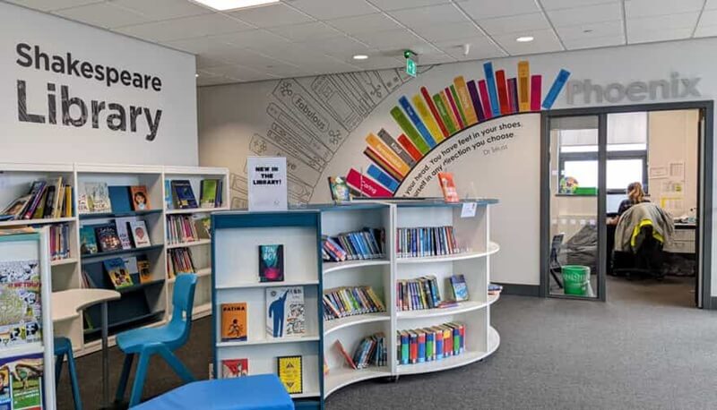 An image of a school's curved bookshelf wall graphics.